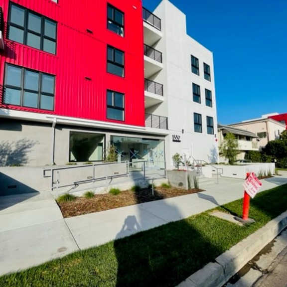 modern apartment building with red and white facade at lido - 1532 brockton ave apartments, california, 90025