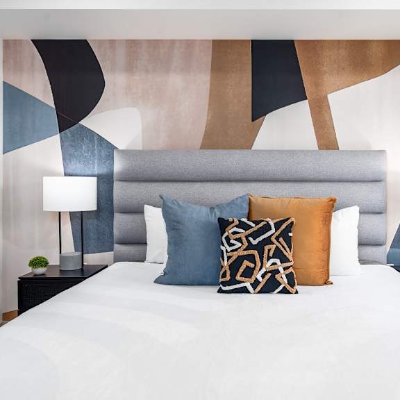 modern bedroom with geometric wall art at lido - 1532 brockton ave apartments, los angeles, ca 90025