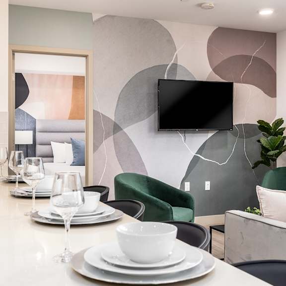 modern dining area with abstract wall mural at lido - 1532 brockton ave apartments, california
