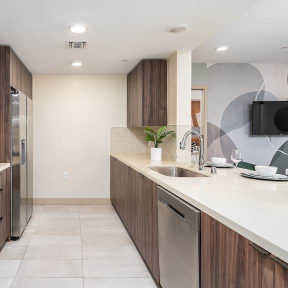 modern galley kitchen with stainless steel appliances at lido - 1532 brockton ave apartments, california, 90025