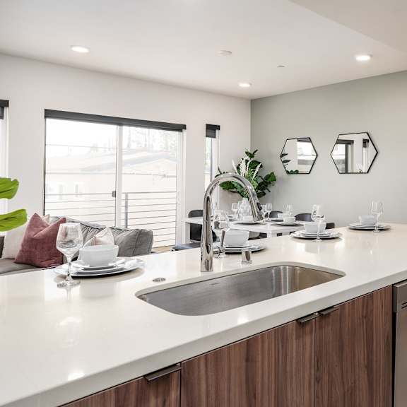 kitchen island with undermount sink and wood cabinets at lido - 1532 brockton ave apartments, los angeles, ca 90025