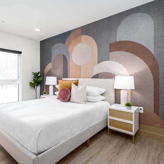 modern bedroom with geometric wall mural at lido - 1532 brockton ave apartments, los angeles, 90025
