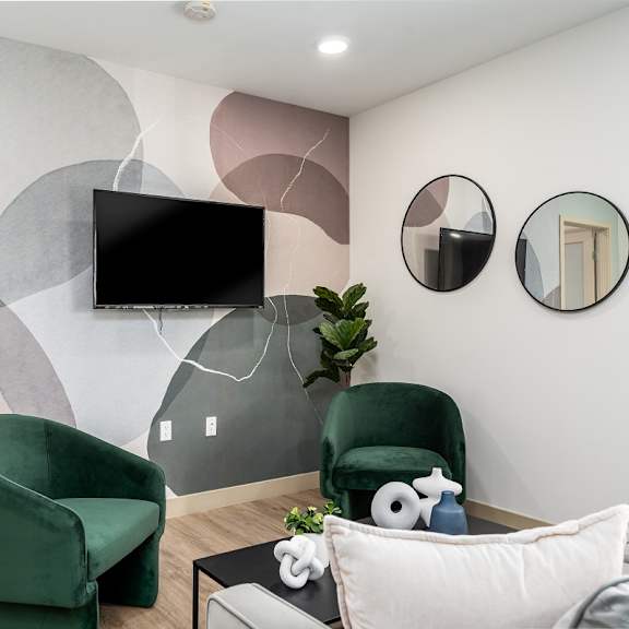 modern living room with colorful abstract wall mural at lido - 1532 brockton ave apartments, california, 90025