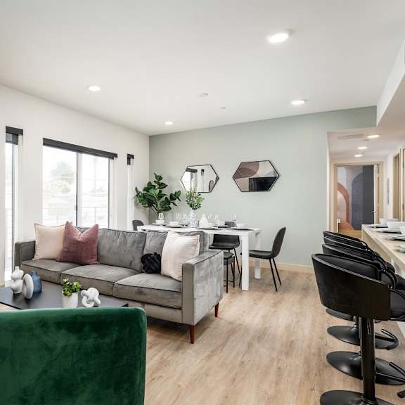 open living space with green velvet chairs at lido - 1532 brockton ave apartments, los angeles, ca