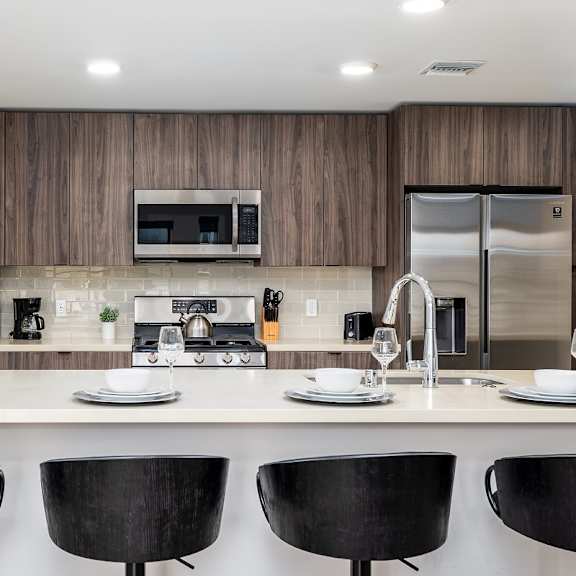 modern kitchen island with bar seating at lido - 1532 brockton ave apartments, los angeles, 90025