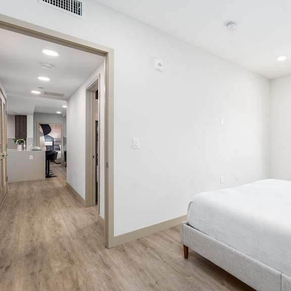 modern bedroom with gray platform bed at lido - 1532 brockton ave apartments, los angeles