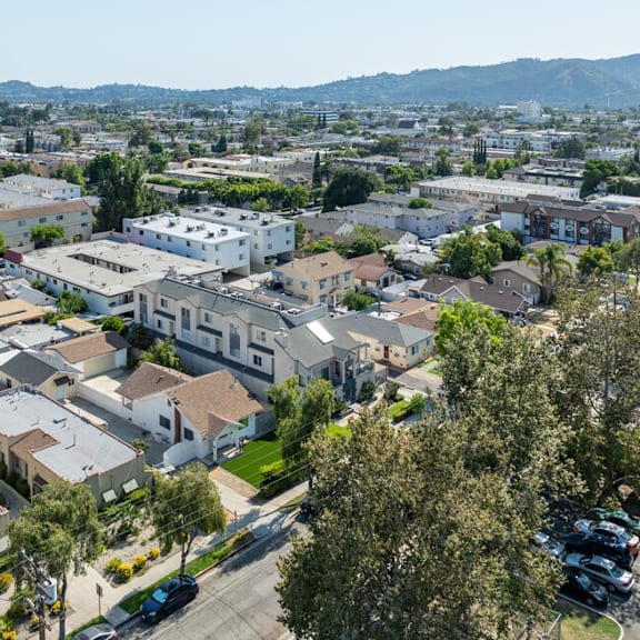 an aerial view of a city with houses and trees