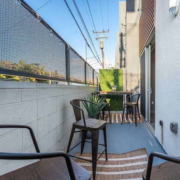 a balcony or terrace with chairs and a table at lido apartments - 4025 grandview, california