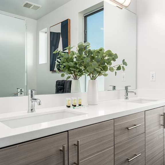 a bathroom with two sinks and a mirror at lido apartments - 4025 grandview, california