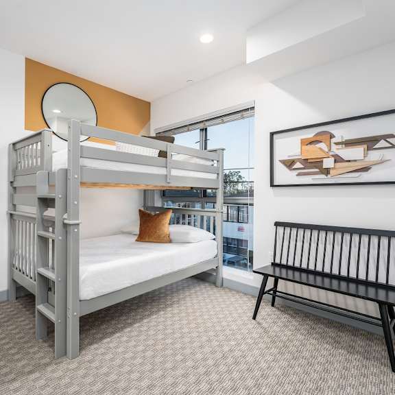 a bunk bed in a bedroom with a window at lido apartments - 4025 grandview, california