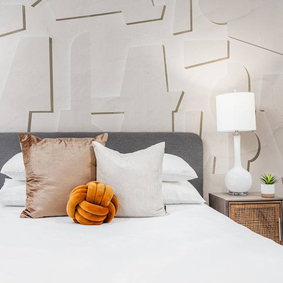 a bedroom with a large bed with white sheets and pillows at lido apartments - 4025 grandview, california, 90066