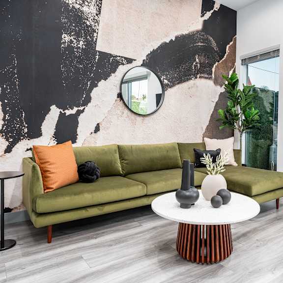 a living room with a geometric tile floor and a green couch at lido apartments - 4025 grandview, culver city, california