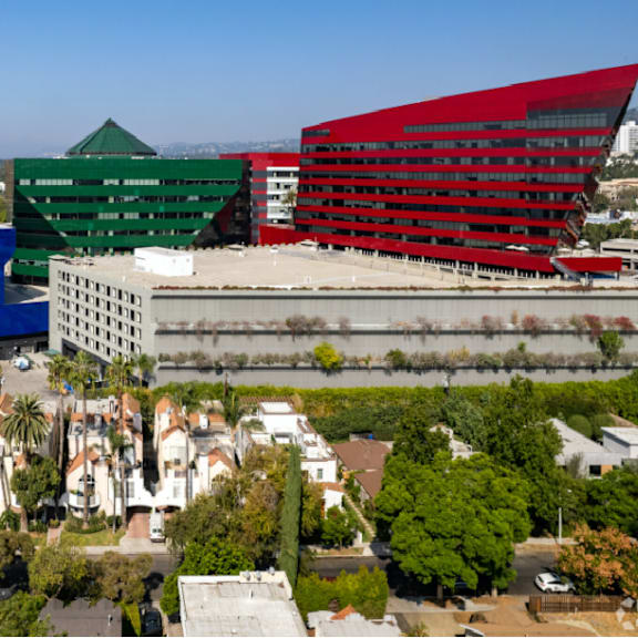a cityscape with buildings in blue, green and red.