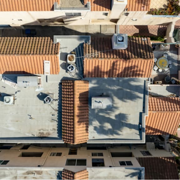 a top-down view of a residential area with terracotta roofs.