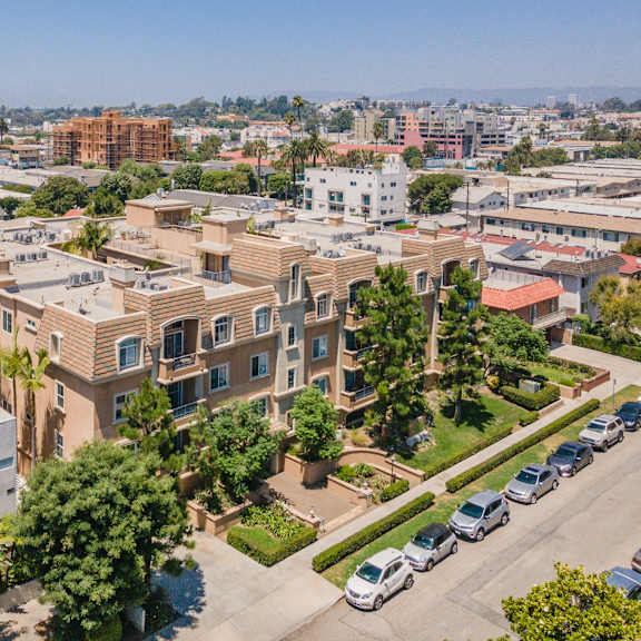 a residential area with apartment buildings and parked cars.