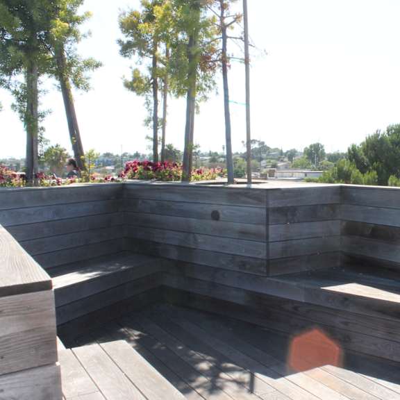 rooftop deck with built in wooden seating at lido - 3714 kelton apartments, los angeles