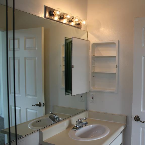 a bathroom with a sink and mirror.