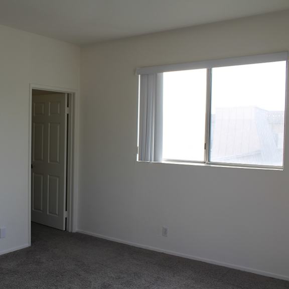 a room with a white door and a window.