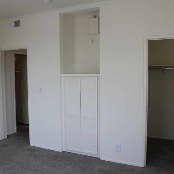 a white room with a door and a closet.