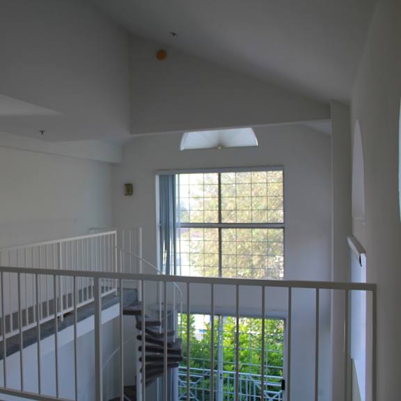 a white interior with a staircase and a window.