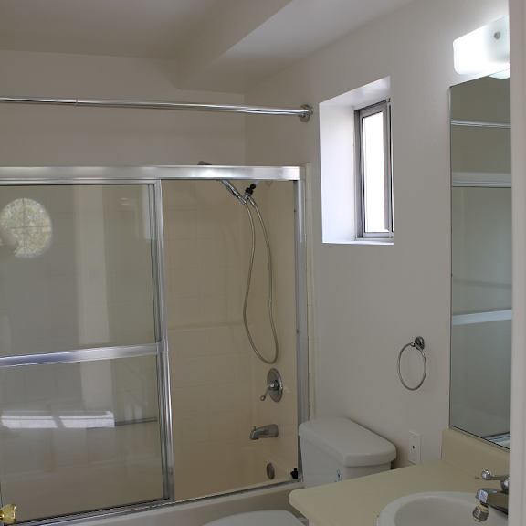 a white toilet sits next to a sink in a bathroom.