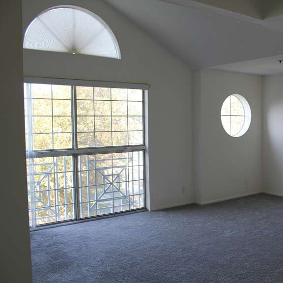 a room with a large window and a balcony.