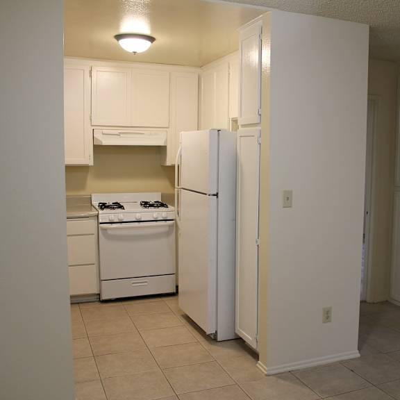 a kitchen with a white refrigerator and a white oven.