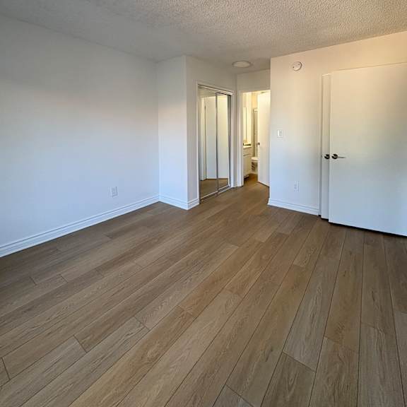 a room with wooden floors and white walls.