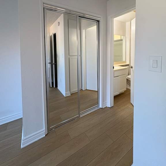 a white bathroom with a walk-in shower and a toilet.