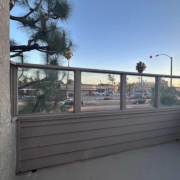 a balcony with a view of a street and buildings.at lido apartments - 101-197 n ridgeway, anaheim, 92801