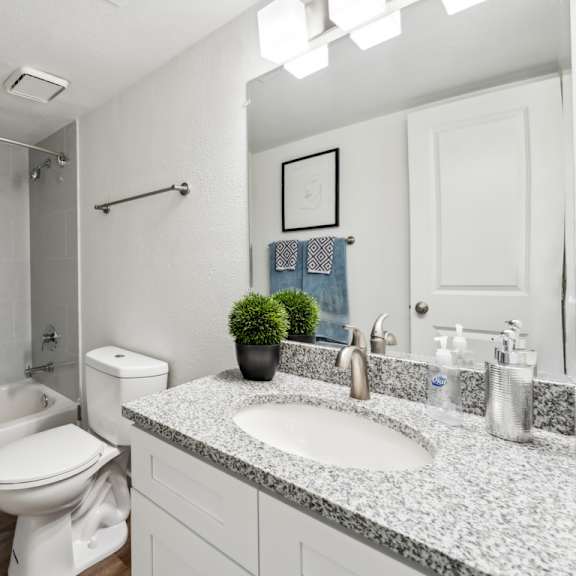 a bathroom with a white toilet, sink, and shower. at linkhorn bay apartments, virginia beach, va