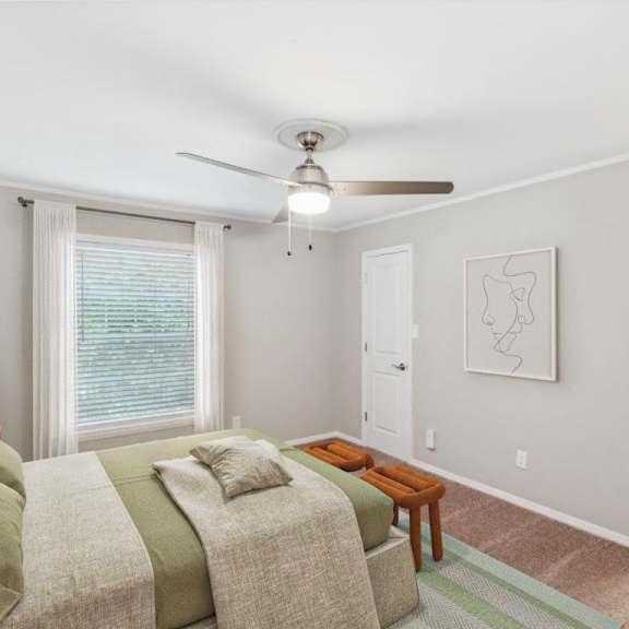 a living room with a couch and a ceiling fan at lake johnson mews, raleigh, nc