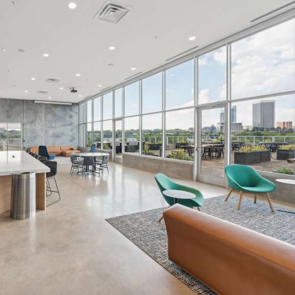 a modern kitchen with a view of the city at south falls tower apartments, richmond, virginia