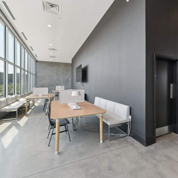 a modern room with a long table and chairs at south falls tower apartments, richmond 23224