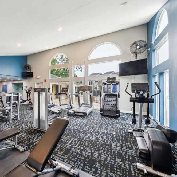 a gym with a variety of equipment including treadmills, weights, and exercise machines at chinoe creek apartments, kentucky, 40502