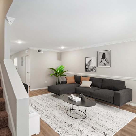 a living room with a staircase and a couch at lake johnson mews, raleigh, north carolina
