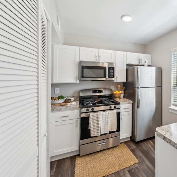 a kitchen with a refrigerator, stove, and microwave at staples mill townhomes apartments, richmond, va