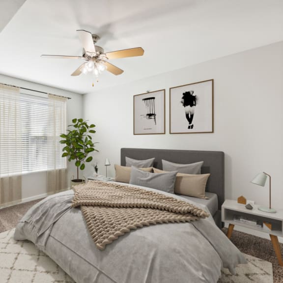 Thumbnail 8 of 8 Open Bedroom with a Large Bed and a Ceiling Fan at 45 Madison Apartments, Kansas City
