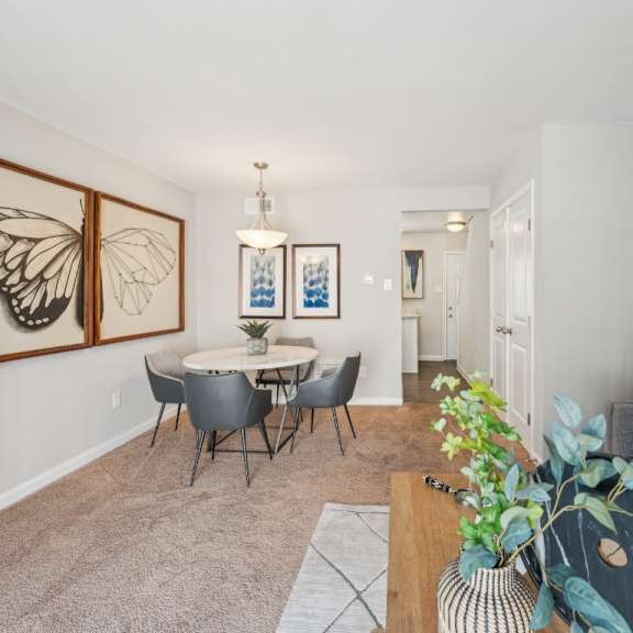 a living room with a dining table and chairs at staples mill townhomes apartments, richmond