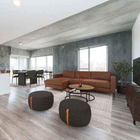 spacious living room with couch and ottomans at south falls tower, richmond, va