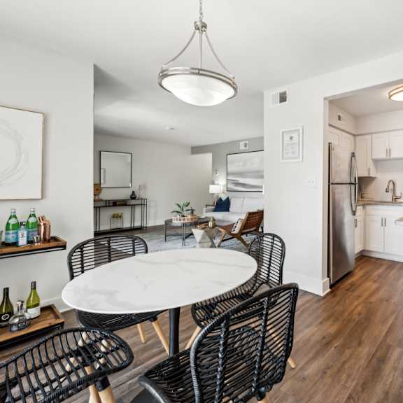 a modern kitchen with a dining table and chairs. at linkhorn bay apartments, virginia beach