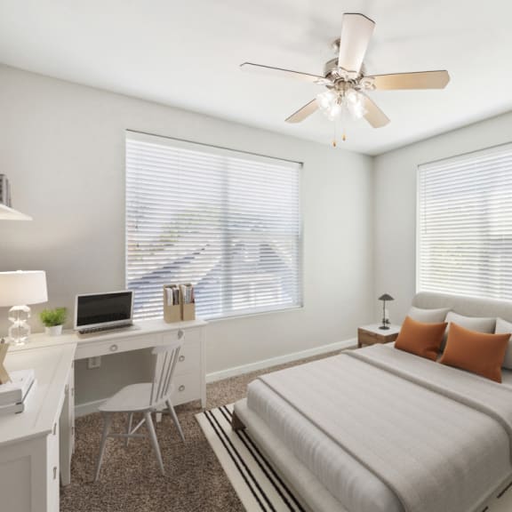 Thumbnail 2 of 8 Bedroom with a Bed and a Ceiling Fan and Two Windows at 45 Madison Apartments, Kansas City