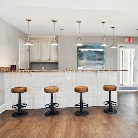 a kitchen with a bar and stools in a living room at ashton creek, virginia, 23831