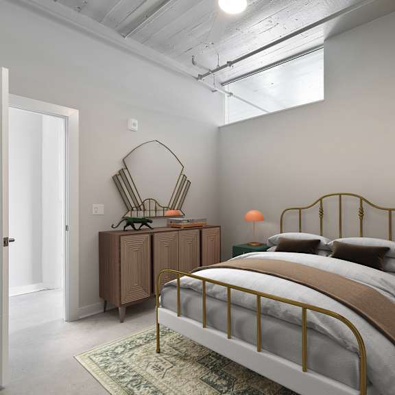 Thumbnail 6 of 7 A bedroom with a bed, nightstand, and lamp.