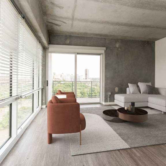 living room with a couch and large windows at south falls tower, richmond, va