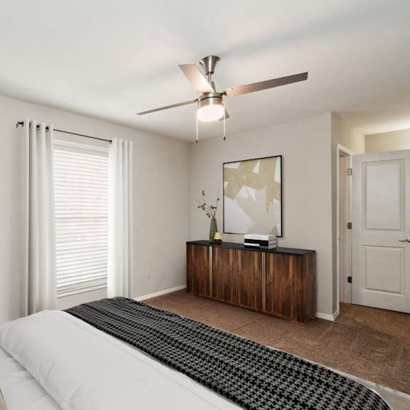 a bedroom with a large bed and a ceiling fan  at lake johnson mews, raleigh, 27606