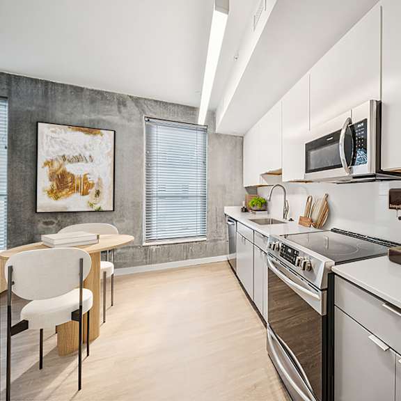 a modern kitchen with white cabinets and stainless steel appliances. at the locks tower, richmond, va, 23219