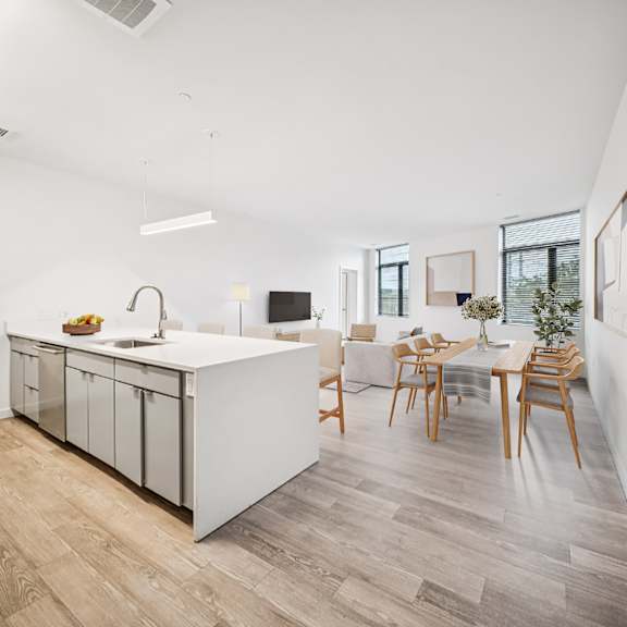 a kitchen with a white counter and wooden chairs. at the locks tower, virginia