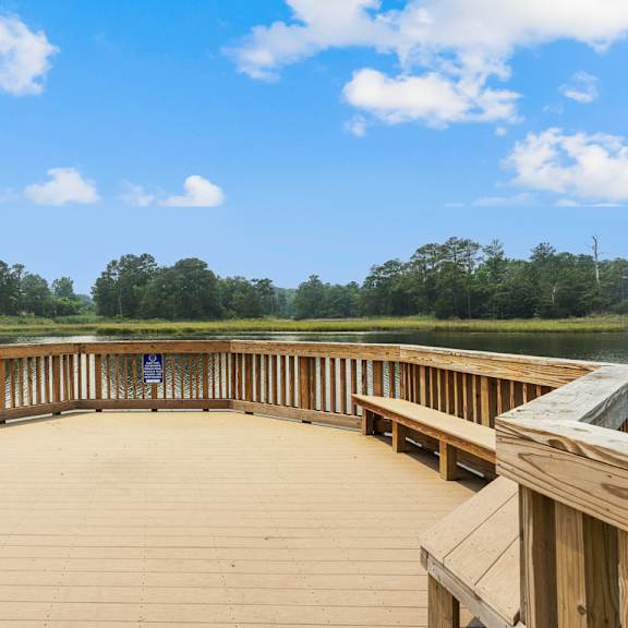 a circular deck with benches overlooking a lake at linkhorn bay apartments, virginia beach 23451