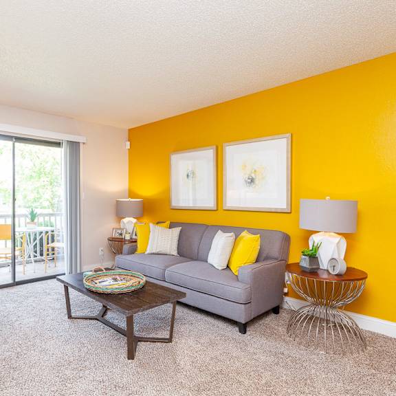 spacious living room with private balcony at the reserve at barry apartments, kansas city, 64154